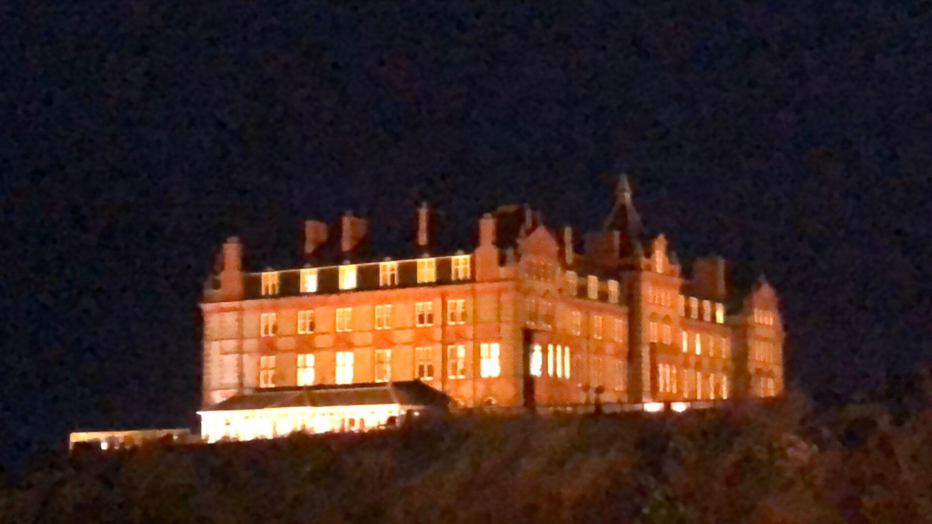 The Headland Hotel in Newquay, Cornwall lit up at night
